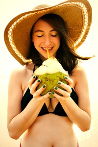 Beautiful girl drinking a fresh coconut