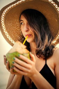 Beautiful girl drinking a fresh coconut