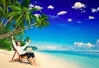 Businessman working remotely from a beach