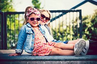 Adorable little fashionistas posing in the sun