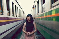 Asian girl walking between trains