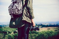 Woman with a camera in the nature