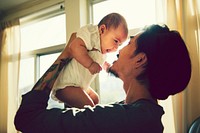 Tattooed father caring for his baby daughter
