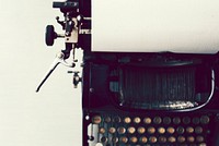 Old typewriter on a white tabletop