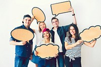 Happy young friends holding up speech bubbles