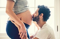 Husband kissing the baby bump