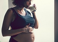 Pregnant woman drinking a glass of milk