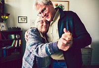Senior couple dancing in the livingroom
