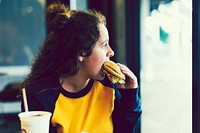 Close up of teenage girl eating a hamburger