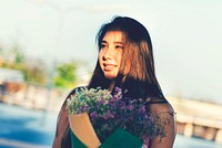 Asian girl carrying a bouquet of flowers
