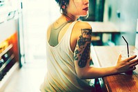Tattooed woman at a cafe