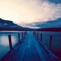 Boat jetty and a calm lake at sunrise, New Zealand