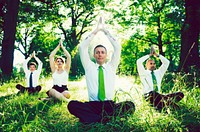 Business people doing yoga outdoors