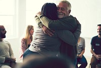 Senior man hugging woman in a support group