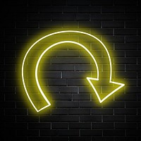 Neon yellow swirl arrow sign on brick wall