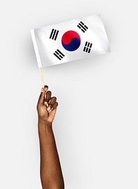 Person waving the flag of South Korea