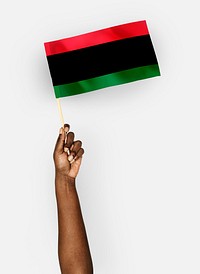 Person waving the flag of Pan-African flag