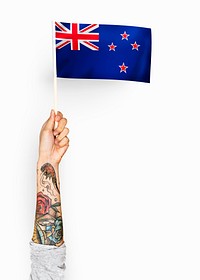 Person waving the flag of New Zealand