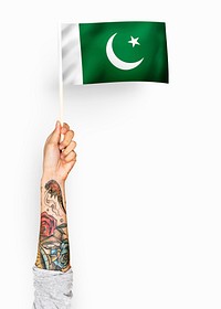 Person waving the flag of Islamic Republic of Pakistan