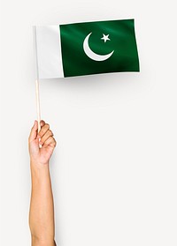 Person waving the flag of Islamic Republic of Pakistan
