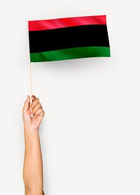 Person waving the flag of Pan-African flag