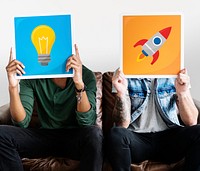 Two friends holding technology signs