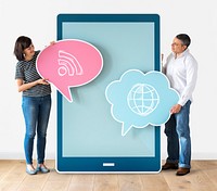 Couple holding speech bubbles and tablet