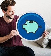 Young man holding a piggy bank icon