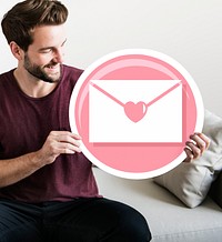 Cheerful man holding love letter icon