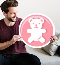 Cheerful man holding teddy bear icon