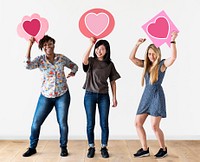 Cheerful women holding heart icons