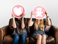 Women holding up valentine icons
