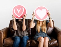 Women holding up valentine icons