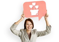 Businesswoman holding speech bubble with heart icon