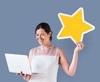 Woman holding a star icon and using a laptop