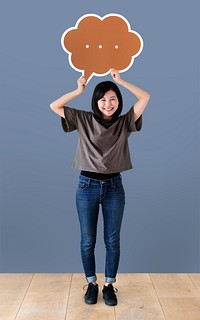 Cheerful woman holding a brown speech bubble icon