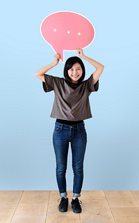 Cheerful woman holding a pink speech bubble