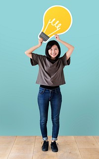Cheerful woman holding a light bulb icon