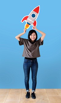 Cheerful woman holding a rocket icon
