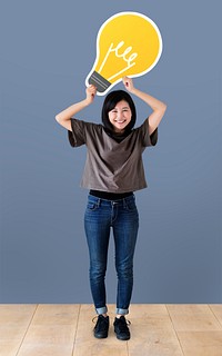 Cheerful woman holding a light bulb icon