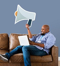 Man showing megaphone icon on couch