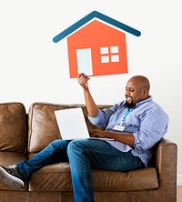 Man showing house icon on couch