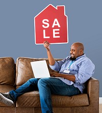 Man holding a house sale icon