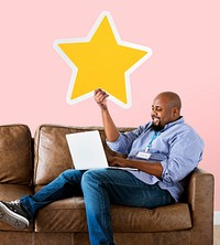 Man showing golden star icon on couch