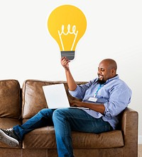 Man showing a light bulb icon on couch