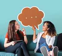 Cheerful women holding brown speech bubble icon