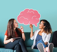 Cheerful women holding a pink brain icon