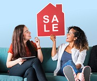 Cheerful women holding a house sales icon