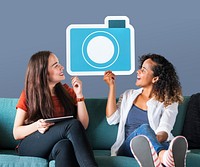 Cheerful women holding a blue camera icon