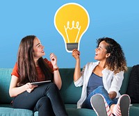 Women holding a light bulb icon on couch
